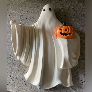 7.28" x 3.03" x 9.72". Made of polyresin & LED lights. Beige & orange color